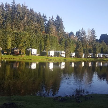 The motorhomes parked in front of the lake